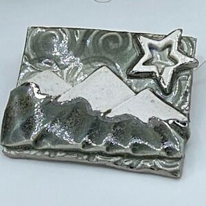 Artisan made ceramic mountain scene brooch